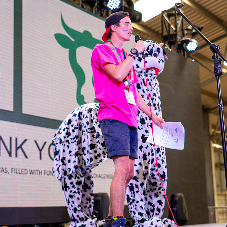 Harry on stage with a Pantomime Cow